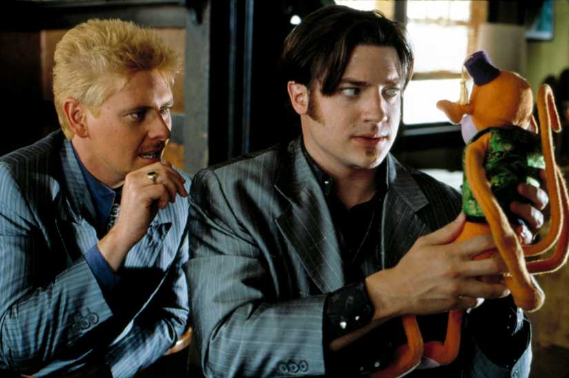 Brendan Fraser and Dave Foley looking at a Monkeybone doll