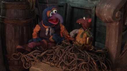 The Muppets Gonzo and Rizzo sit on a pile of rope on the deck of a ship in a scene from Muppet Treasure Island
