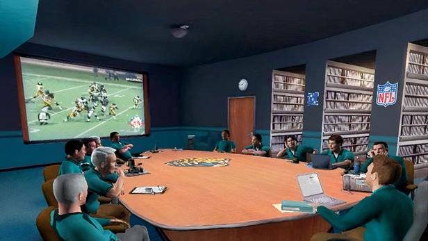 Coaches sit around a boardroom in NFL Head Coach.