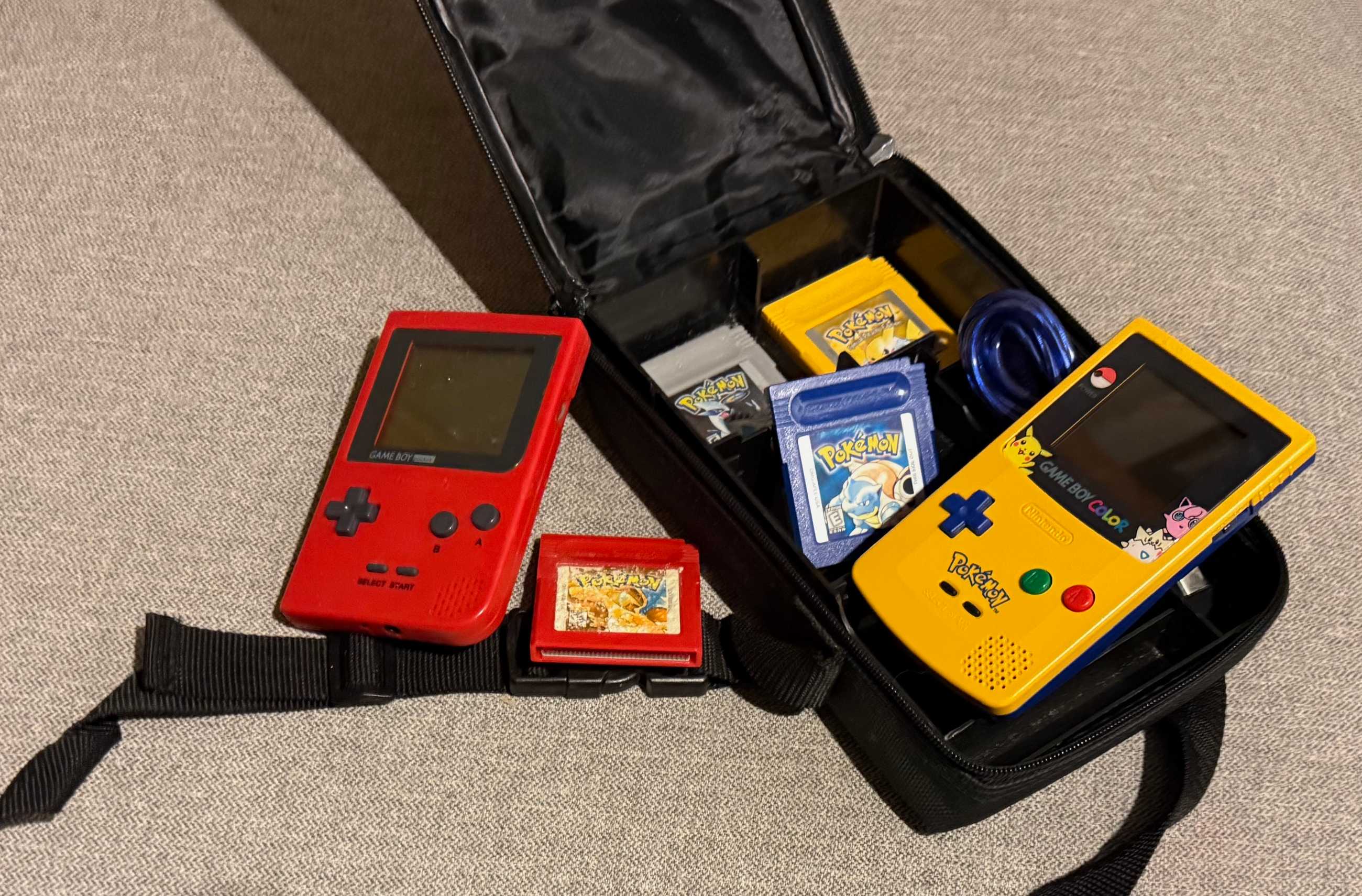 Image of two Game Boys and four Pokémon games