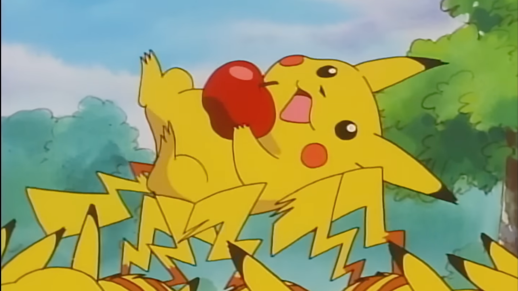 A group of Pikachu lift Ash's Pikachu into the air to celebrate. Ash's Pikachu is holding a red apple.