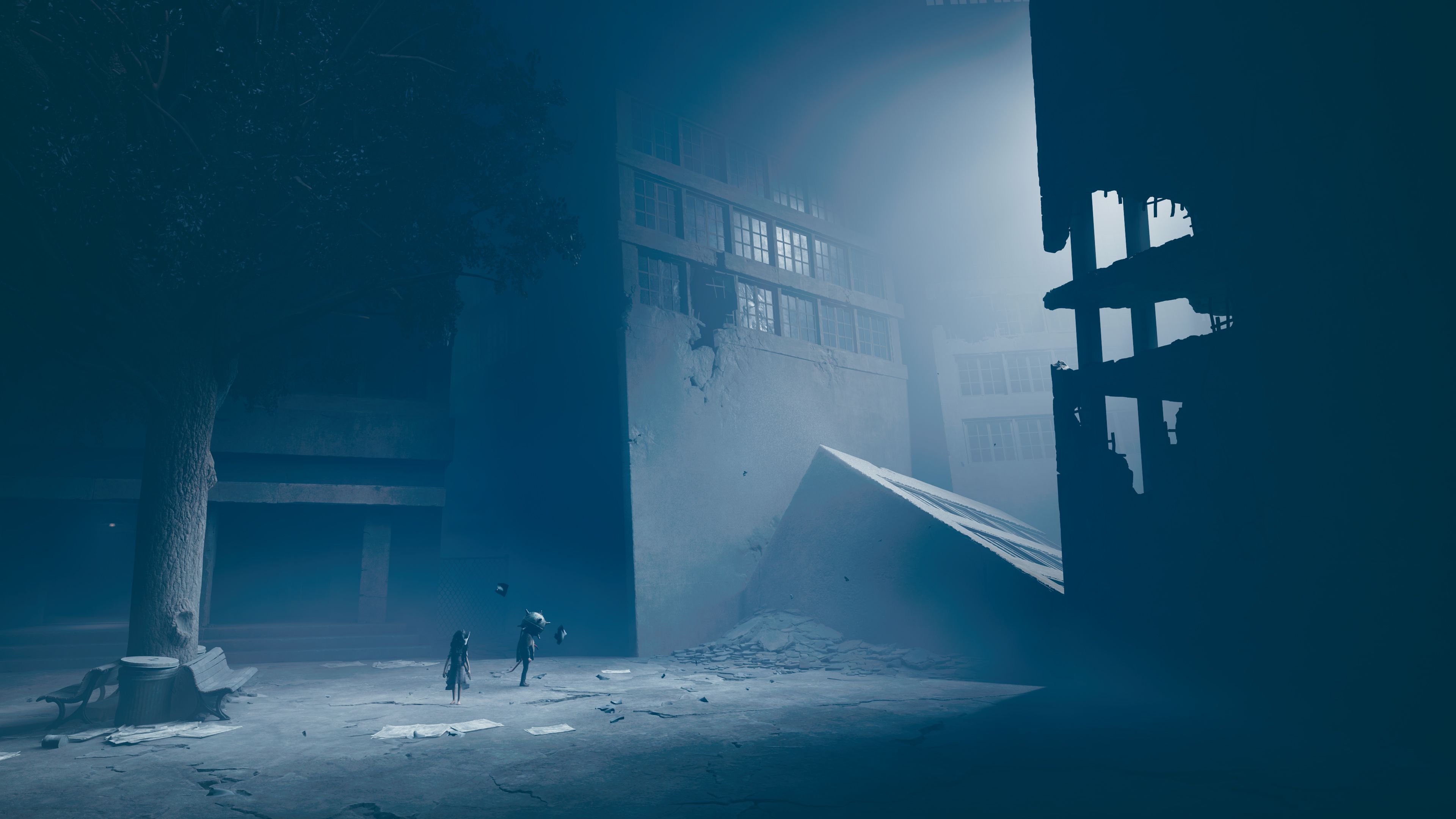 A cinematic wide shot of a desolate town square, showcasing the game's dynamic camera work.