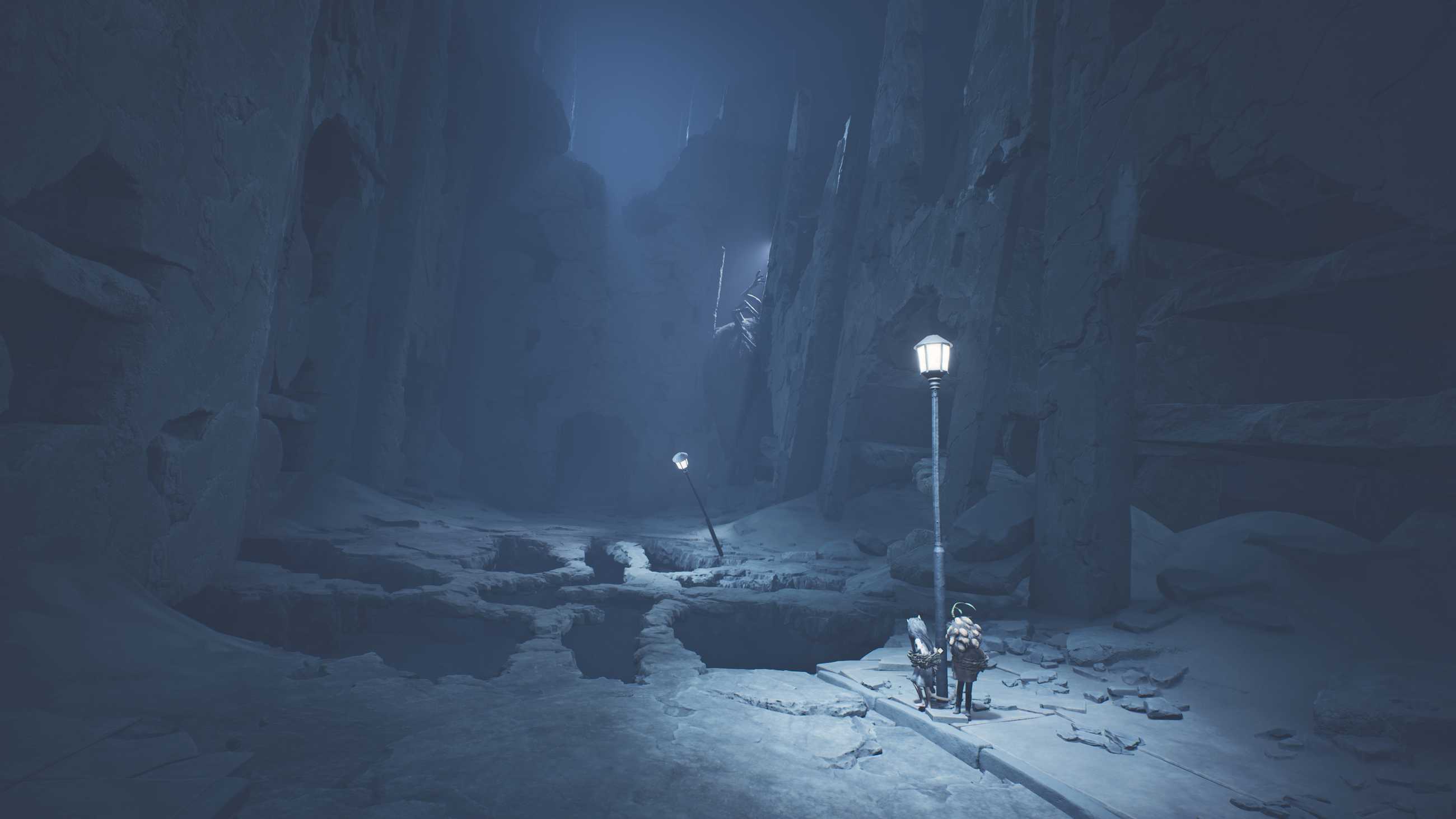 Two kids look upon a chasm with a large monster behind it in Reanimal.