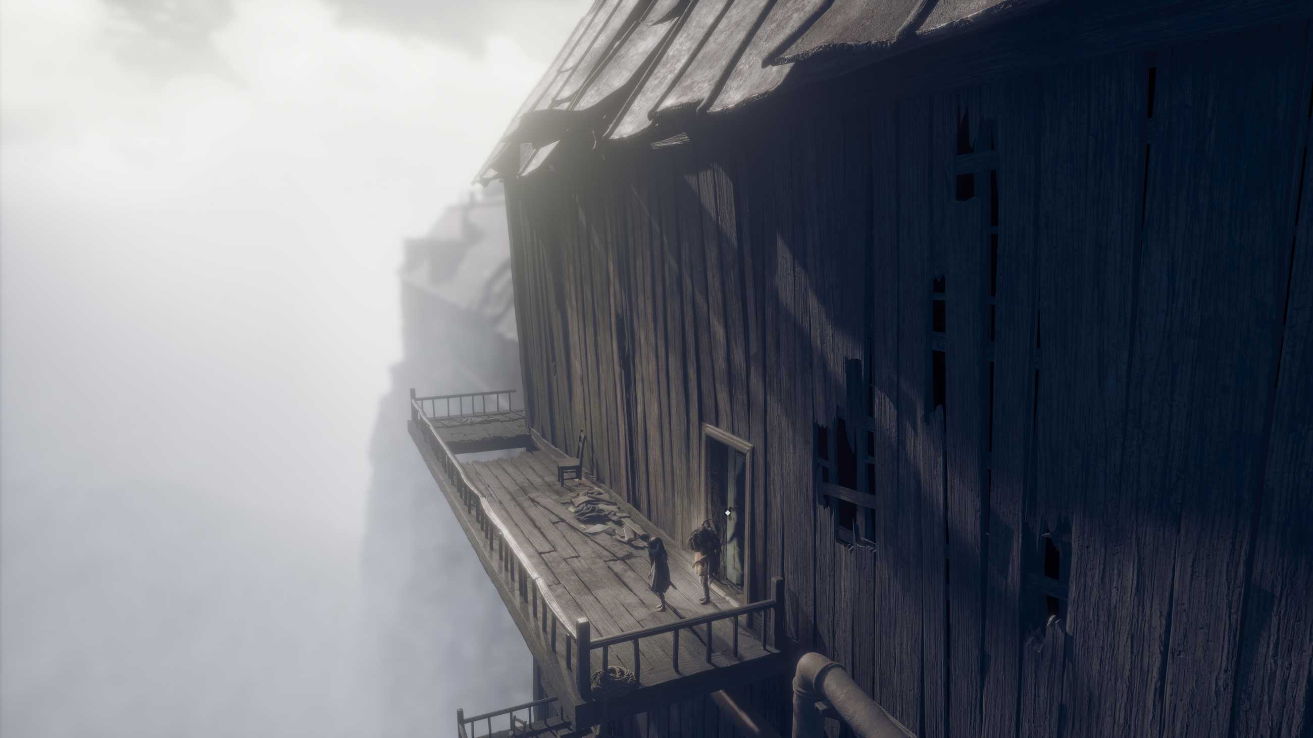 A house with a balcony and a doorway with an interaction dot in Reanimal.