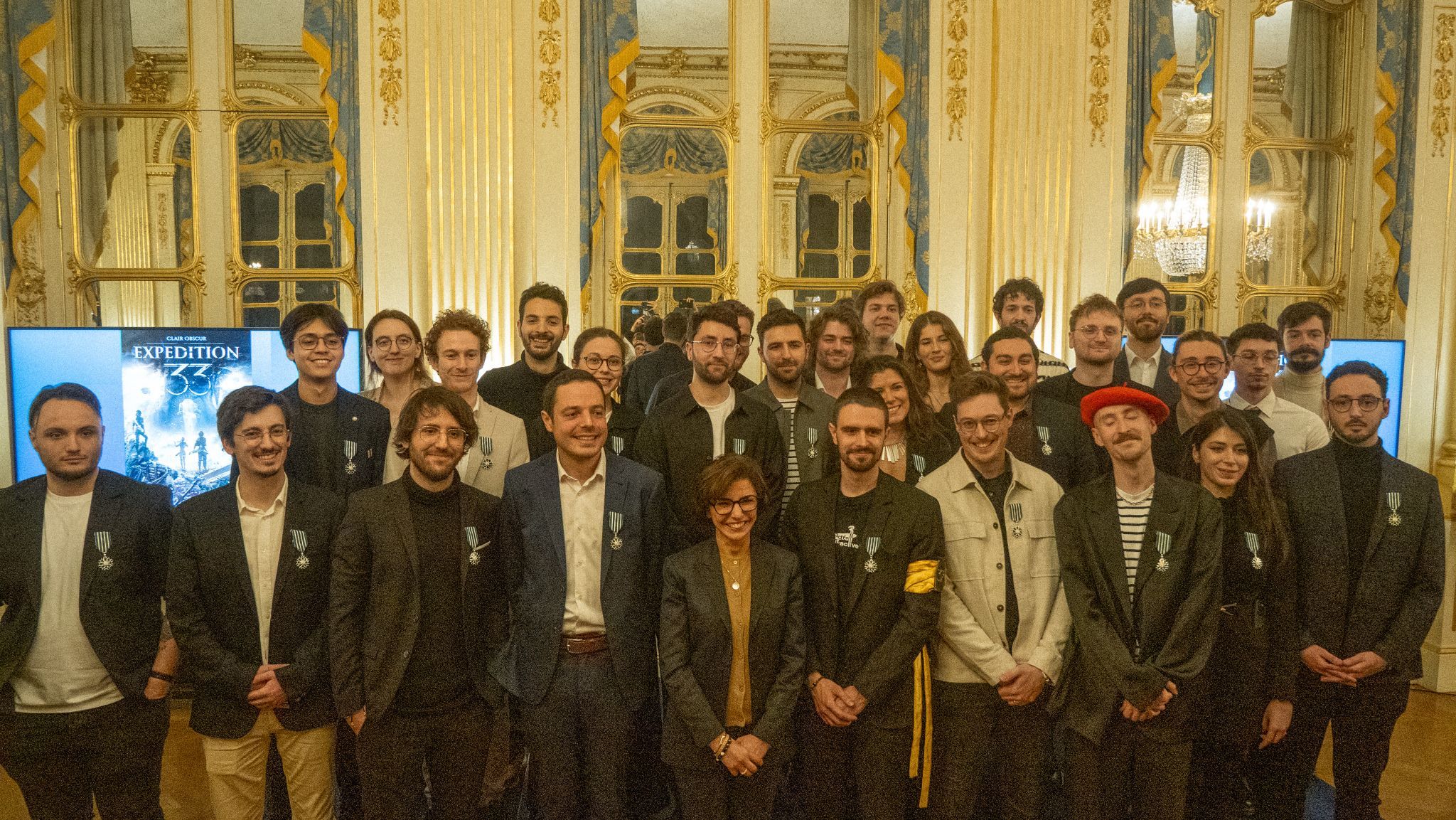 The team at Sandfall Interactive posing with Knight medallions awarded by the French Ministry of Culture.