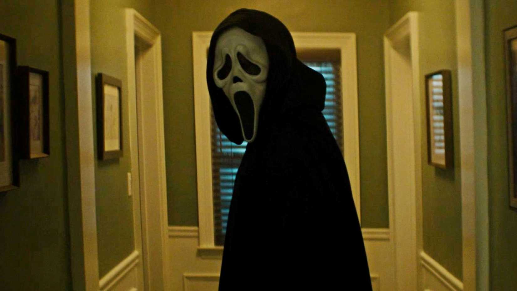 The menacing figure of Ghostface standing at the end of a long hallway in Scream 7