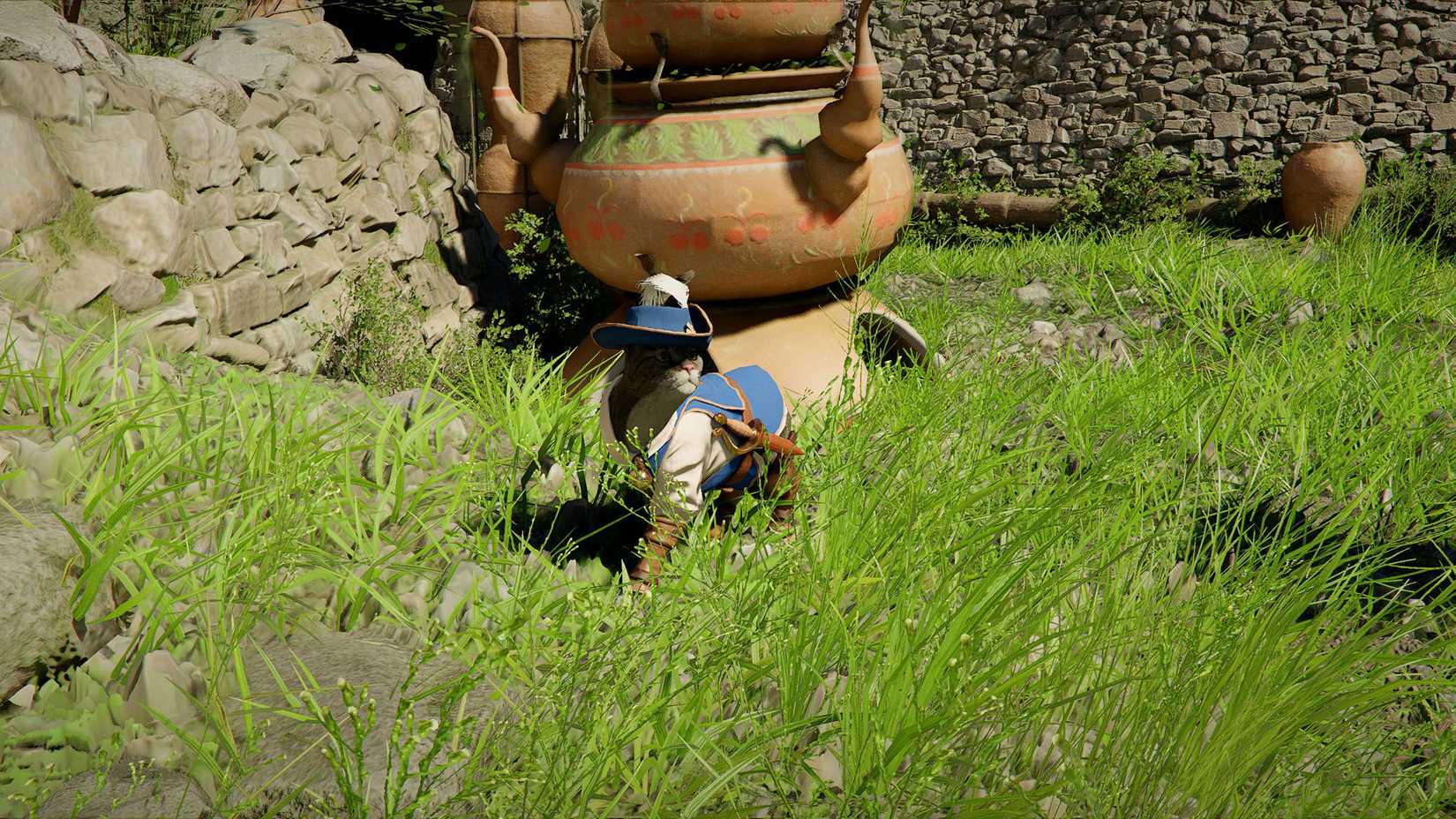A cat wearing a blue musketeer outfit and standing in grass in Crimson Desert.