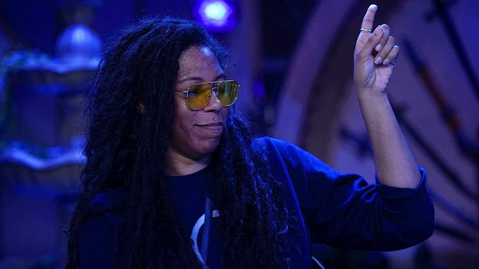 An image featuring Aabia Iyengar from Critical Role. She points up at the air with a satisfied look on her face.