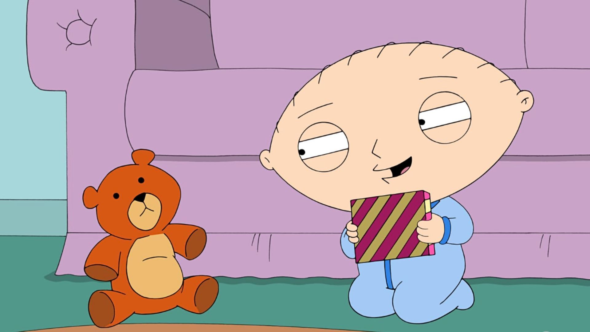 An image from Fox's Family Guy. It features Stewie, an evil toddler with a football shaped head, looking menacingly at his cuddly teddy bear.