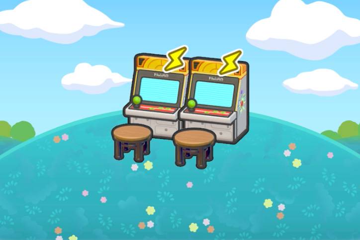 Two arcade cabinets and two stools sitting atop a grassy hill in Pokémon Pokopia.