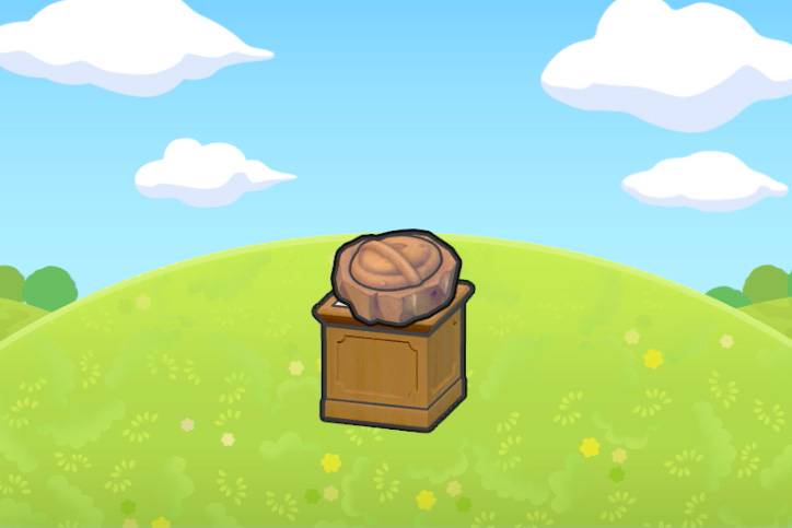 An armor fossil, which looks like a shield, sitting on top of a pedestal on a grassy hill in Pokémon Pokopia.