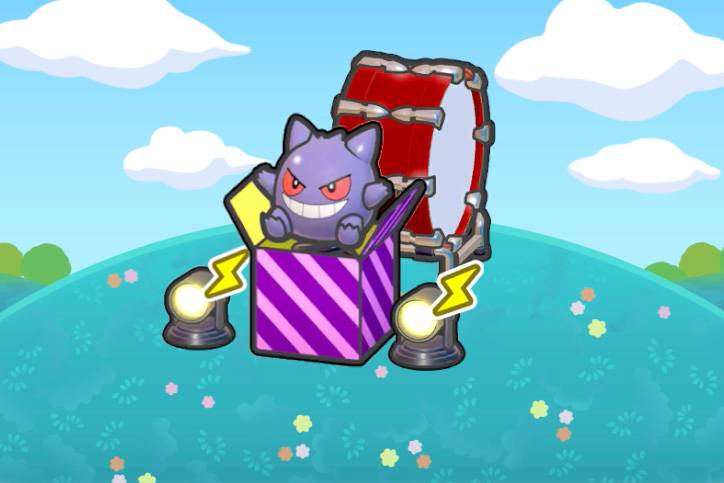 A Gengar jack-in-the-box in between two lights and in front of a large red drum in Pokémon Pokopia.