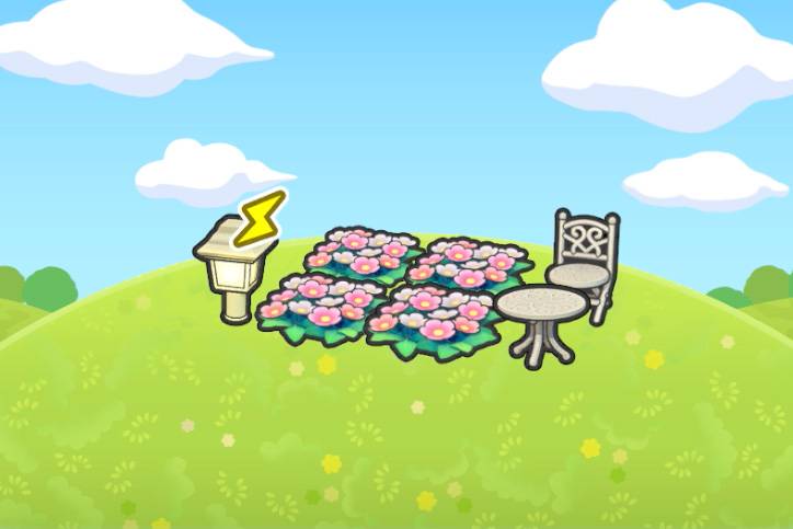 White garden furniture near some flowers in Pokopia.