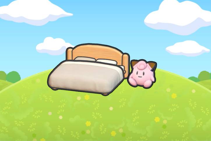 A bed with a Clefairy plush next to it in Pokopia.