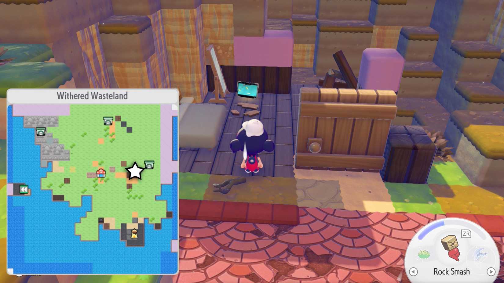 A glowing yellow tablet screen on the ground of the ruins of an old house in Pokopia.