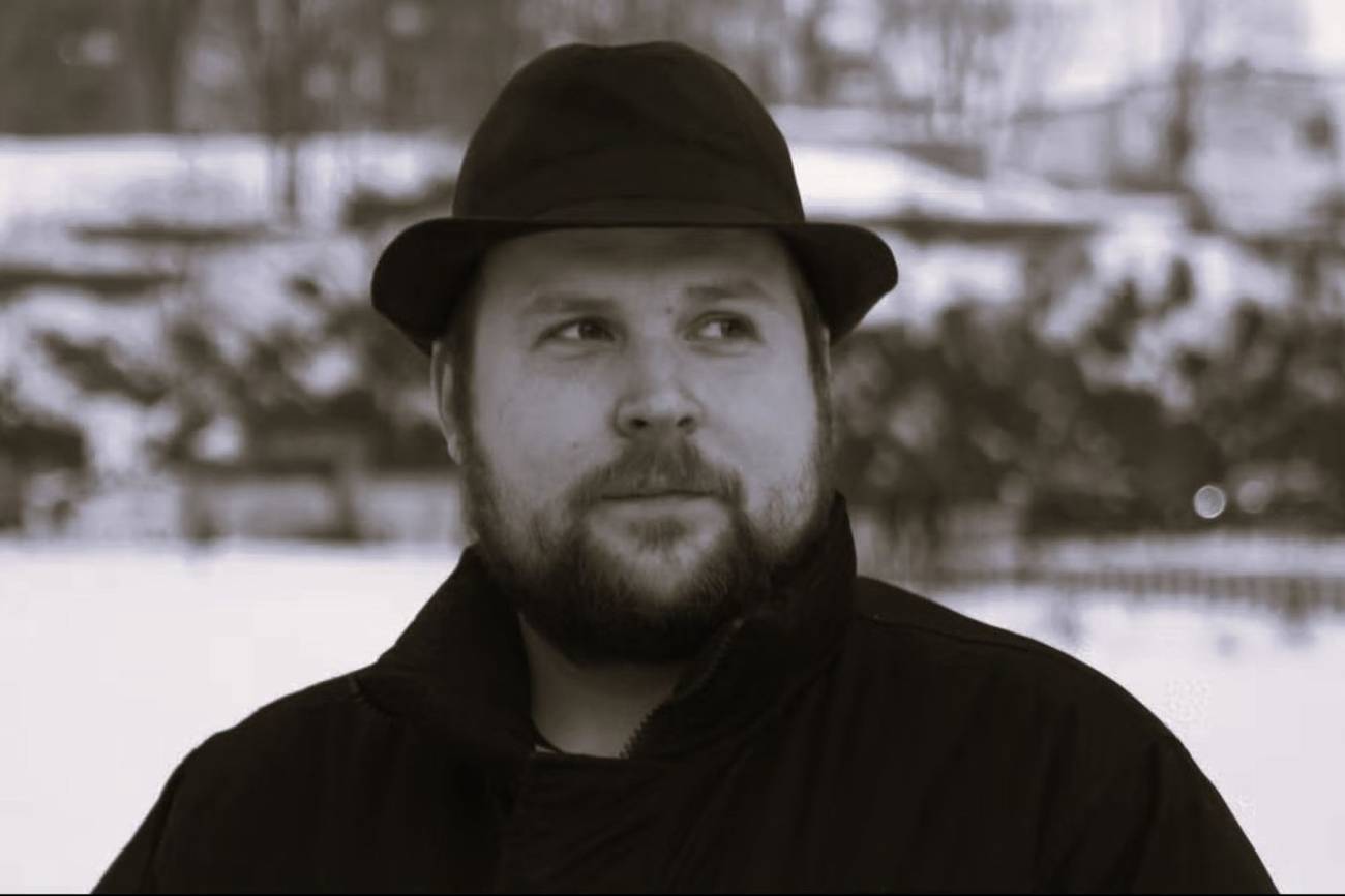 Markus "Notch" Persson against a snowy background wearing a black fedora