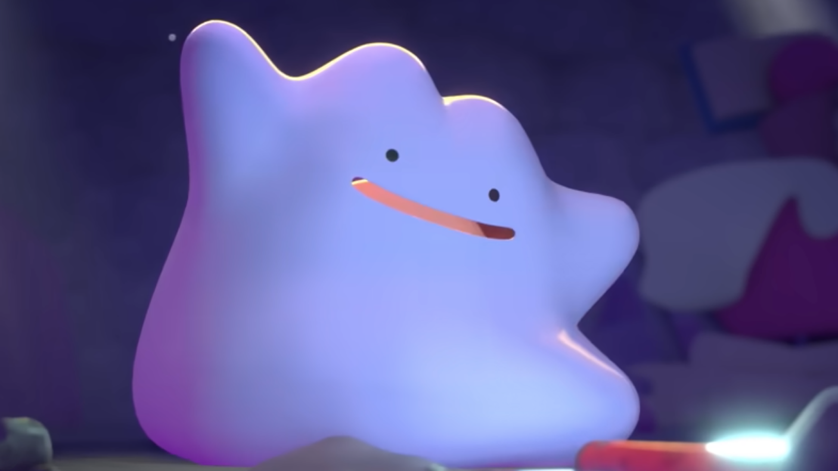A close-up shot of Ditto, a blobby purple Pokémon. Ditto is smiling and looking down and to the right.