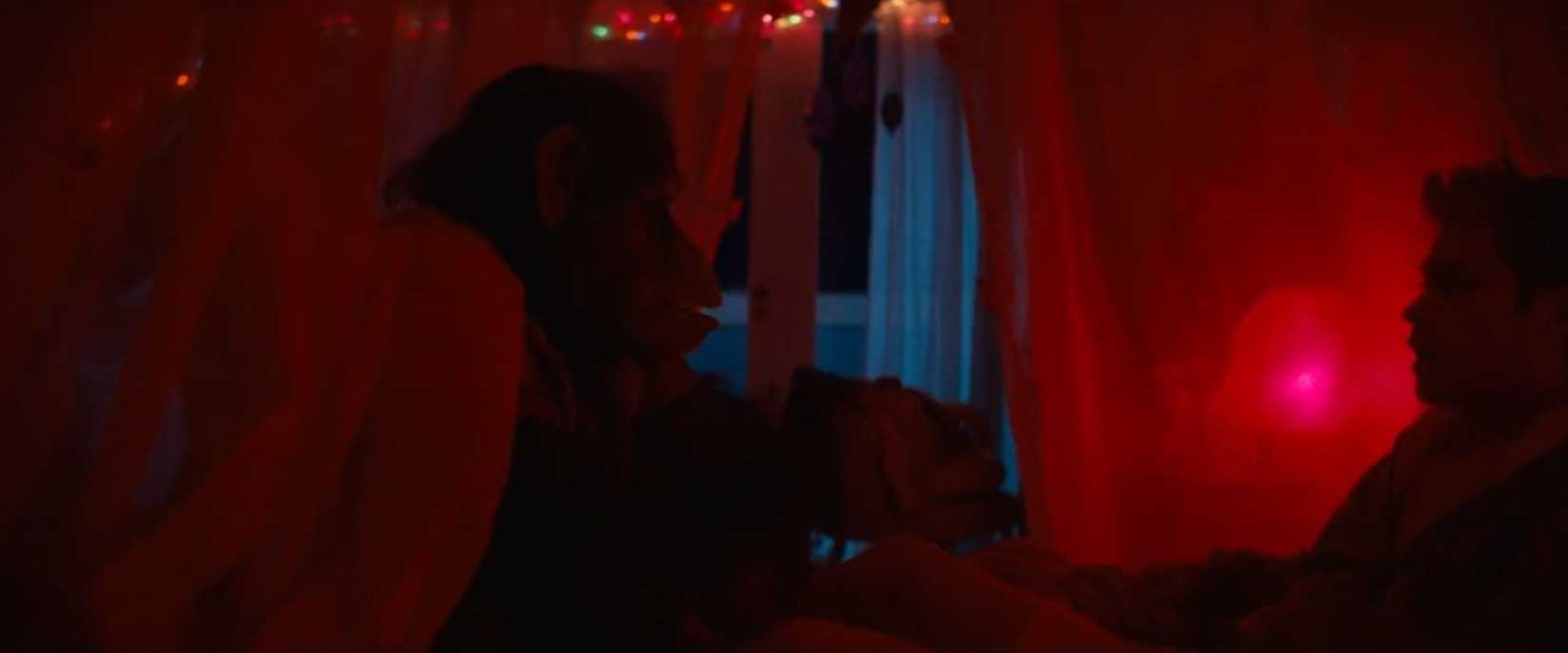 A menacing chimp in a red-lit room from the movie Primate