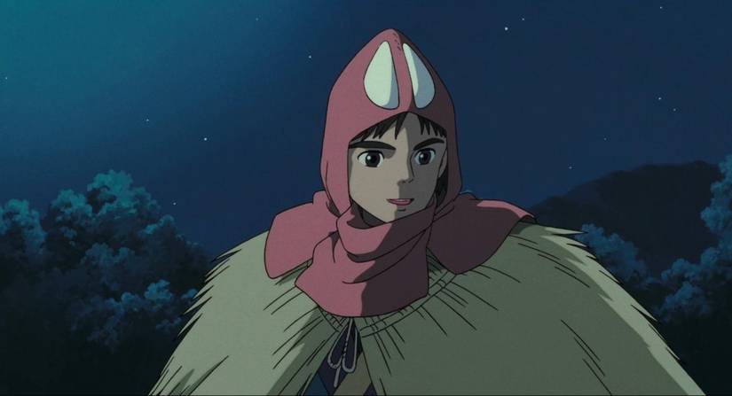A young man with a red and white hood looks hopeful in Princess Mononoke