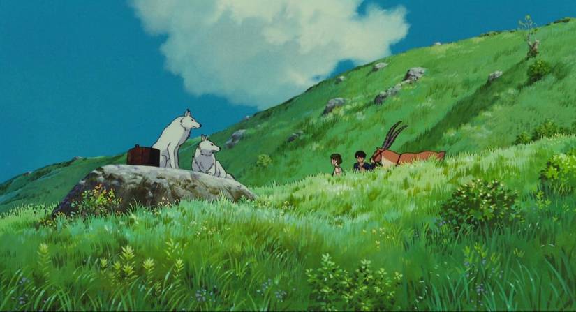 Ashitaka and San sit together in the meadow as the wolves look on in Princess Mononoke