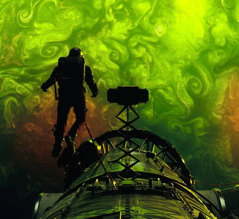 Ryan Gosling floats in space in front of a green plasma swirl