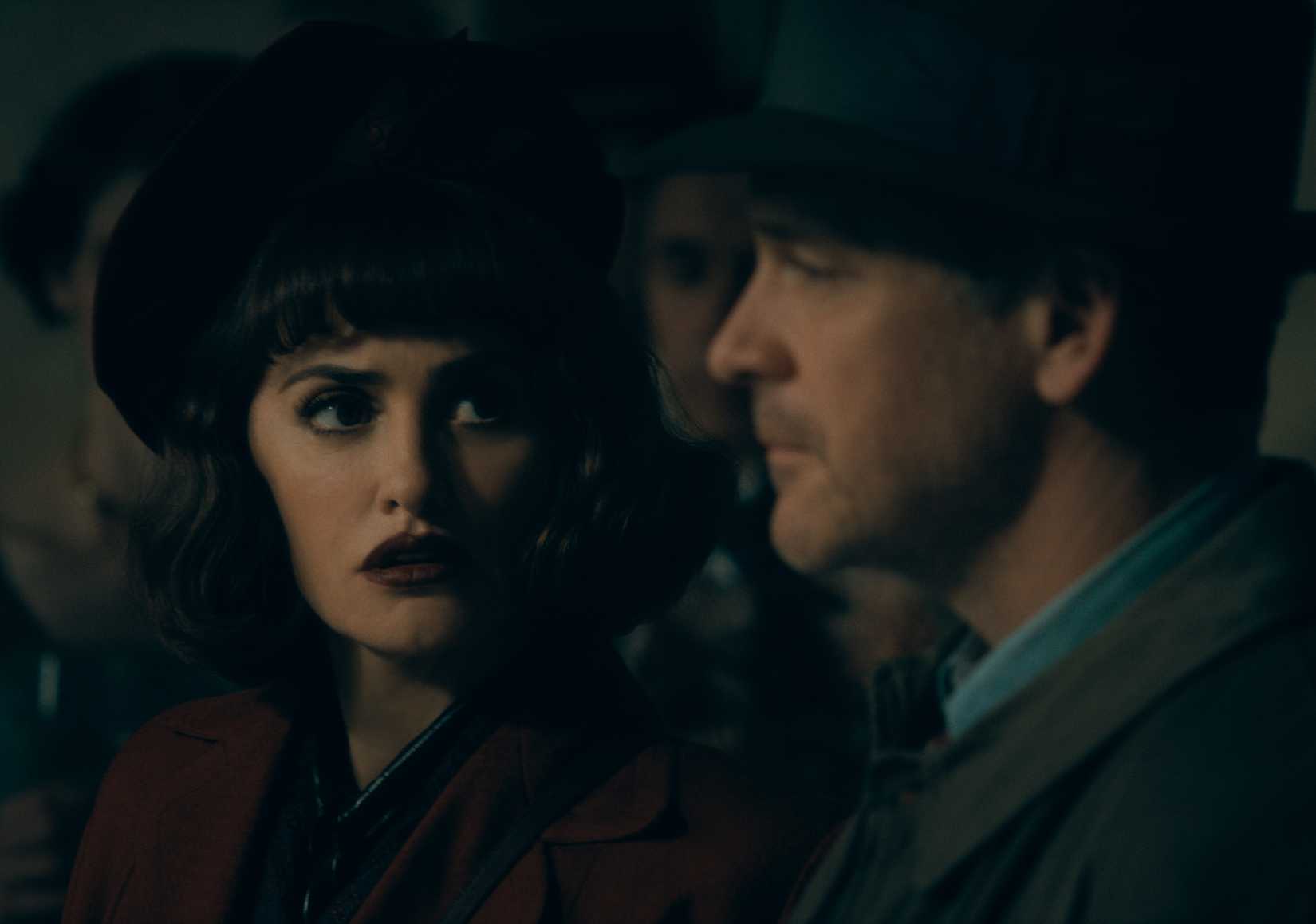 Myrna (Penélope Cruz), a dark-haired woman in a beret with a betrayed expression on her face, sits in a car at night with Jake Wiles (Peter Sarsgaard) in The Bride!