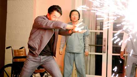 James Kyson Lee blasts a wall with an explosion of sparks as Masi Oka stands by in Heroes