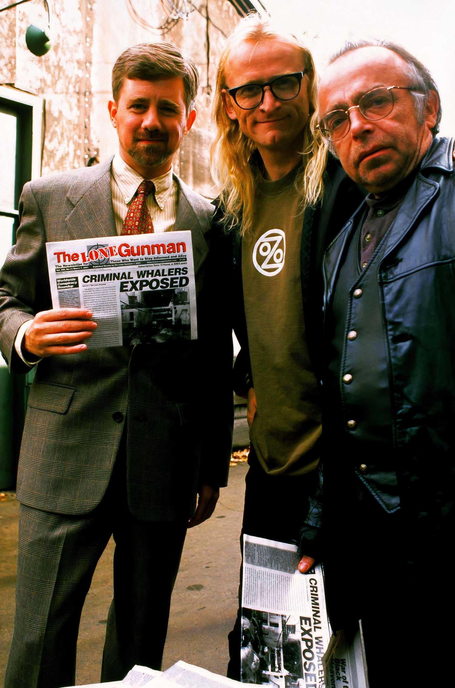 Byers, Langly and Frohike hold a copy of The Lone Gunman tabloid