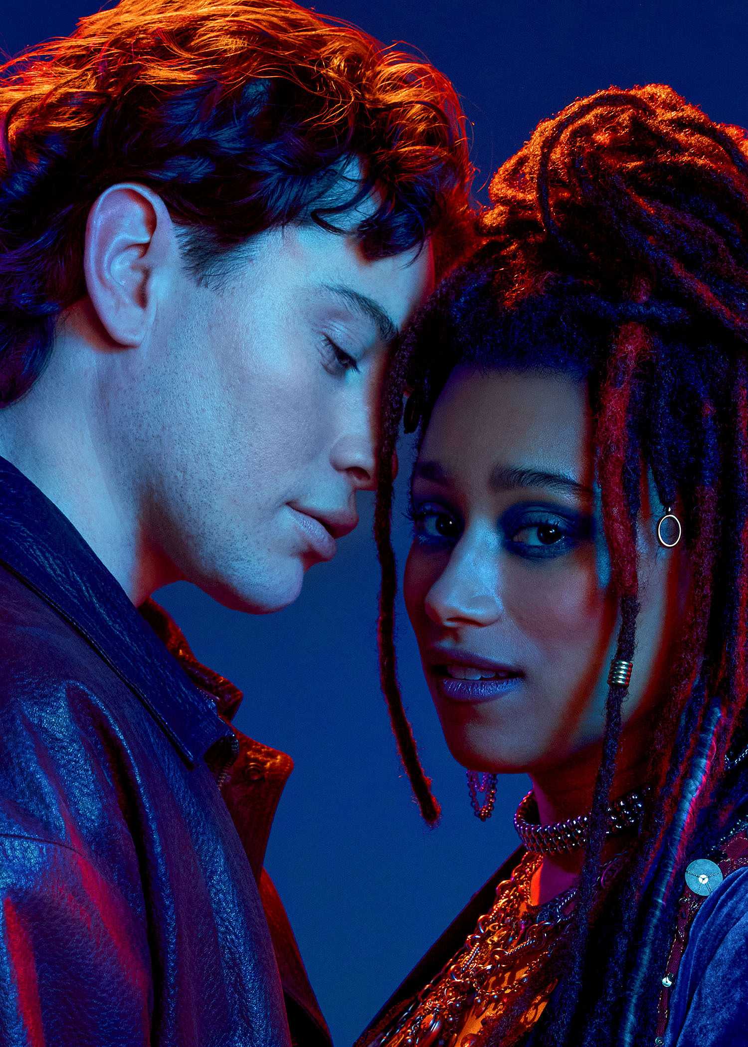 Michael (LJ Benet), a teen in a leather jacket, leans in to kiss Star (Maria Wirries), a woman wearing a lot of silver jewelry in The Lost Boys