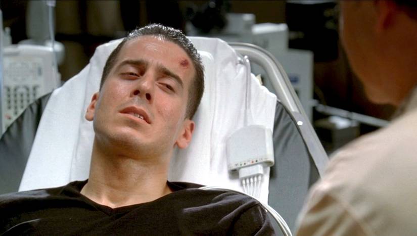 Charlie Francis (Kirkland M. Acevedo), a young man with a cut on his head wearing a T-shirt and sweating, lies in a hospital bed in the Fringe episode "Unleashed"