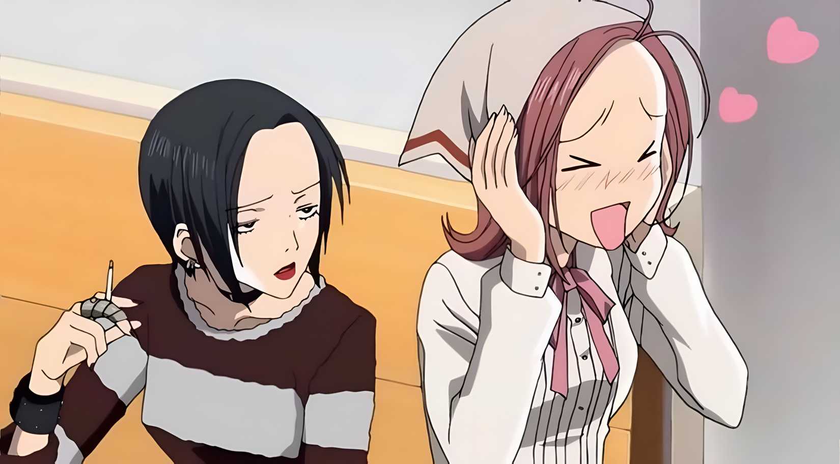 A girl with short, jet black hair smokes a cigarette while her friend blushes with joy with Nana