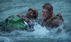Army sergeant 81 (Alan Ritchson) screams as he swims across a raging river, dragging a wounded fellow soldier, in War Machine