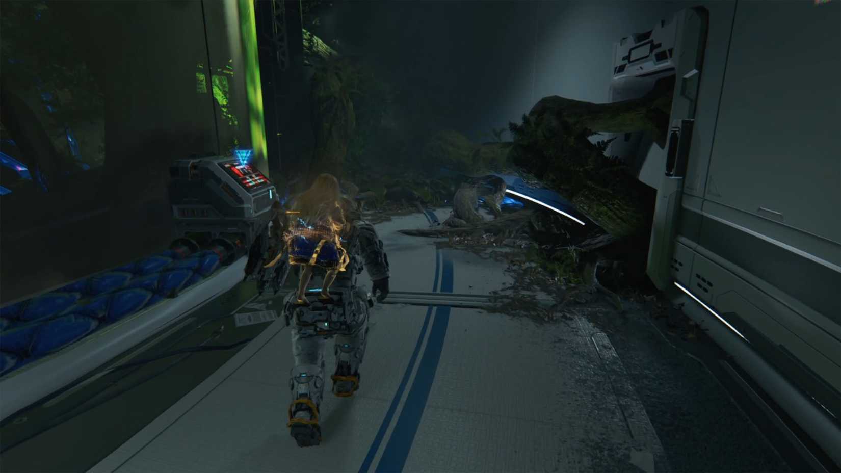 A man carrying a girl on her back heading down a hallway wwith a control panel on their left in Pragmata.