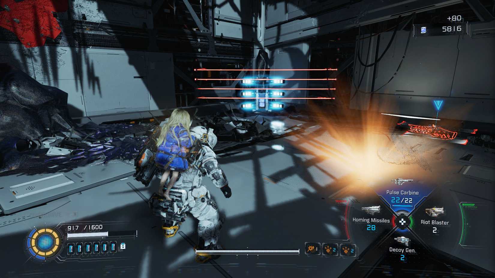 A man carrying a girl on his back looking at a series of lasers in the corner of a room.