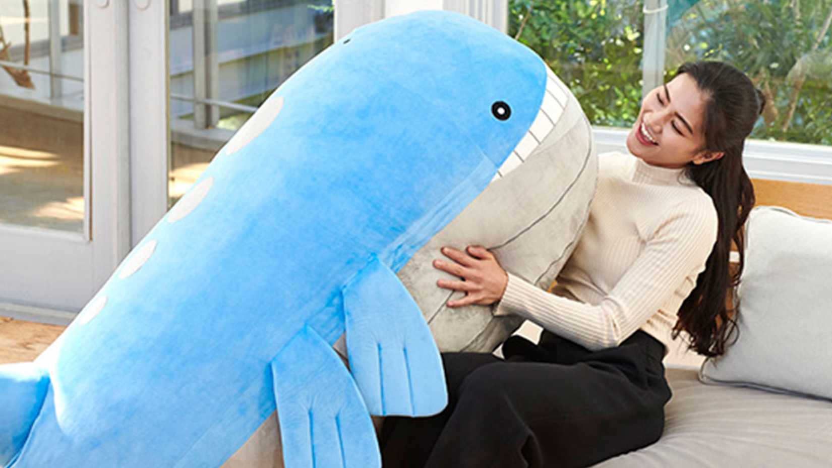 Wailord plush on a woman's lap