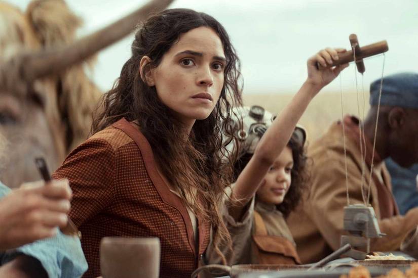 Adria Arjona in Andor as Bix Caleen, looking back at the viewer with distress