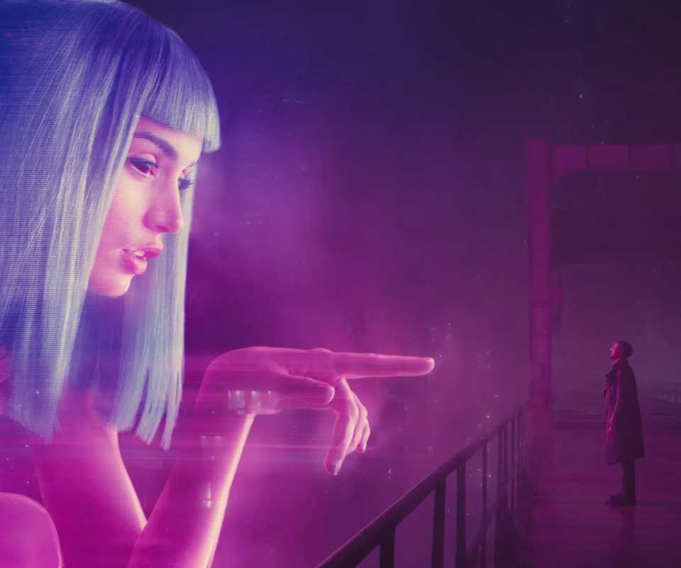 Still from Blade Runner 2049 featuring K and a blown up hologram of the fictional Joi AI.