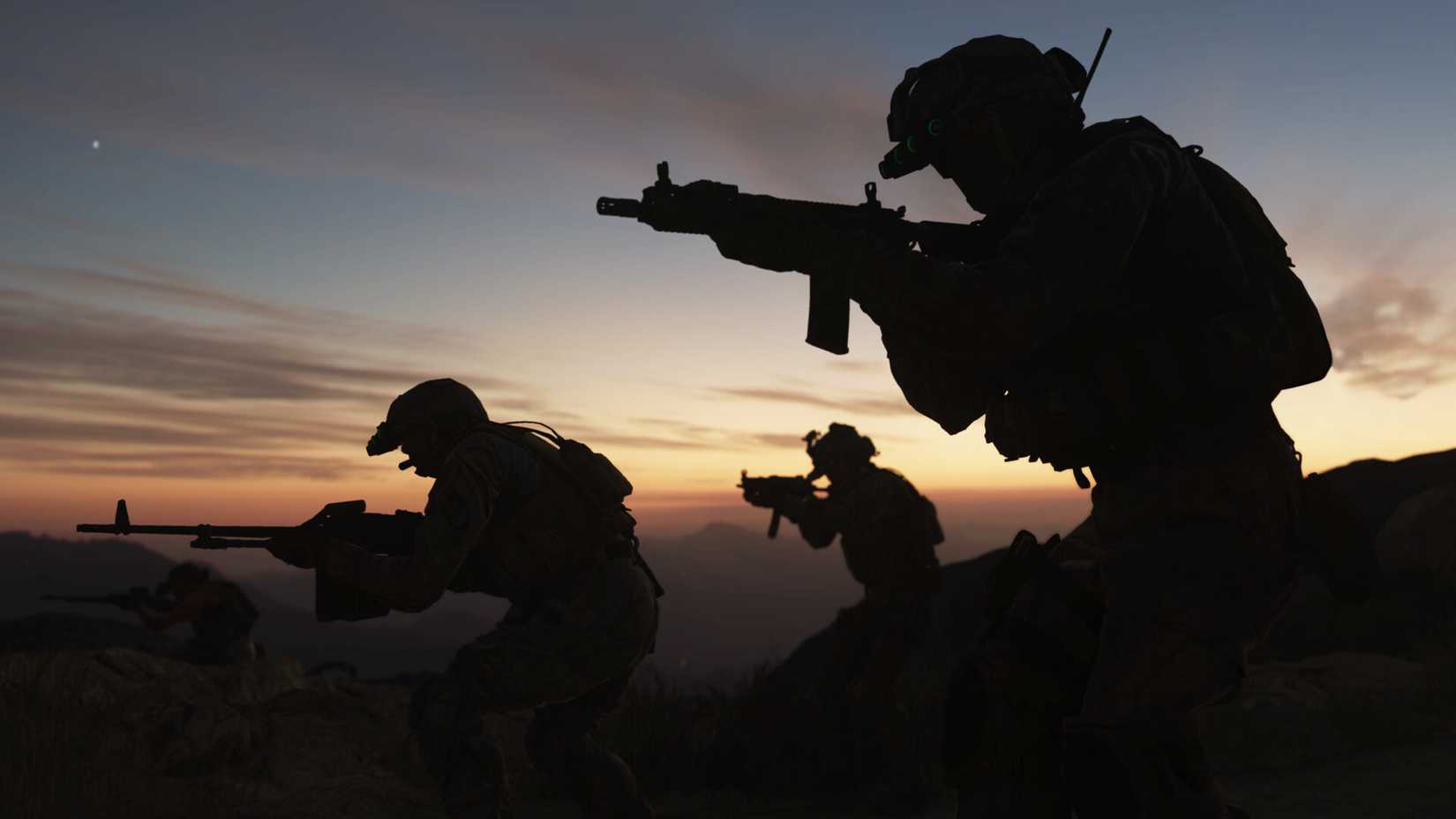 Soldiers carrying rifles silhouetted against a dawn sky in Call of Duty: Modern Warfare