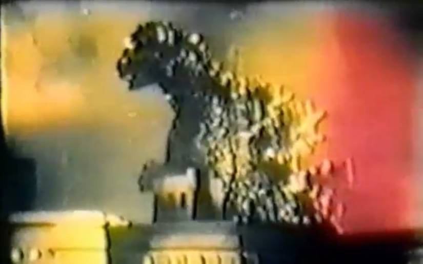 Still from the italian movie Cozzilla featuring Godzilla in a psychadelic hue. 