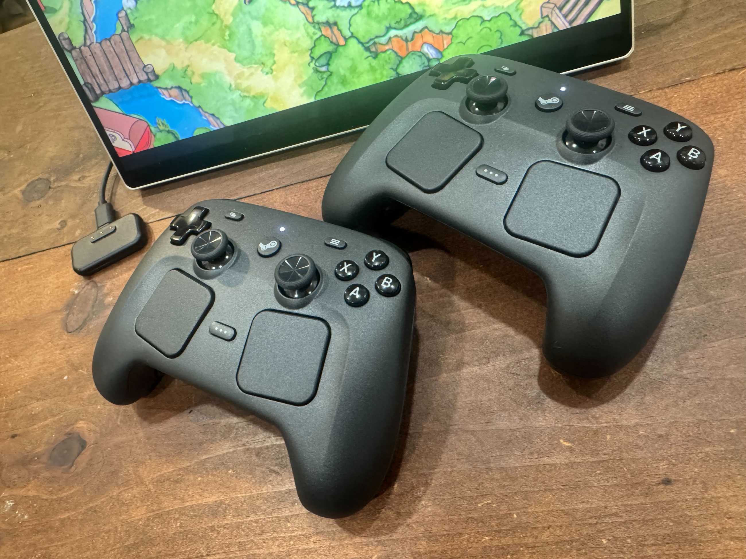 Two Steam Controllers sit on a table.