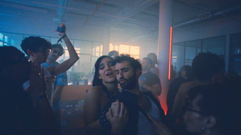 Two people dancing in a crowded club