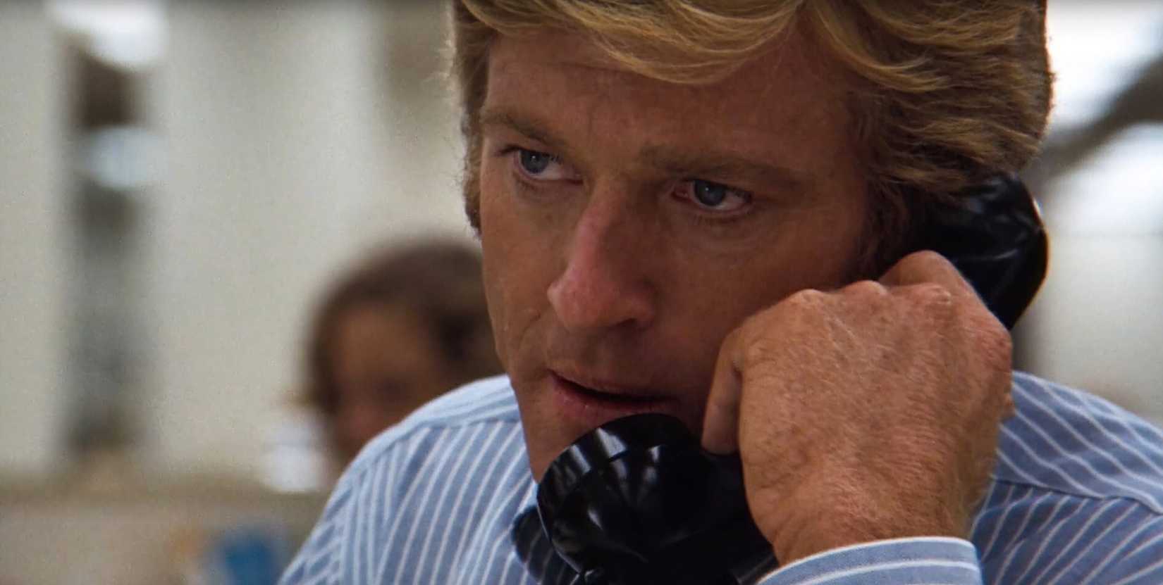 Robert Redford as Bob Woodward talks on the phone