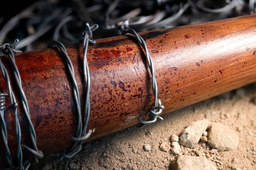 An extreme close-up of one of The Walking Dead's props — "Lucille," the bloody, barbed-wire-wrapped bat Negan uses as a weapon