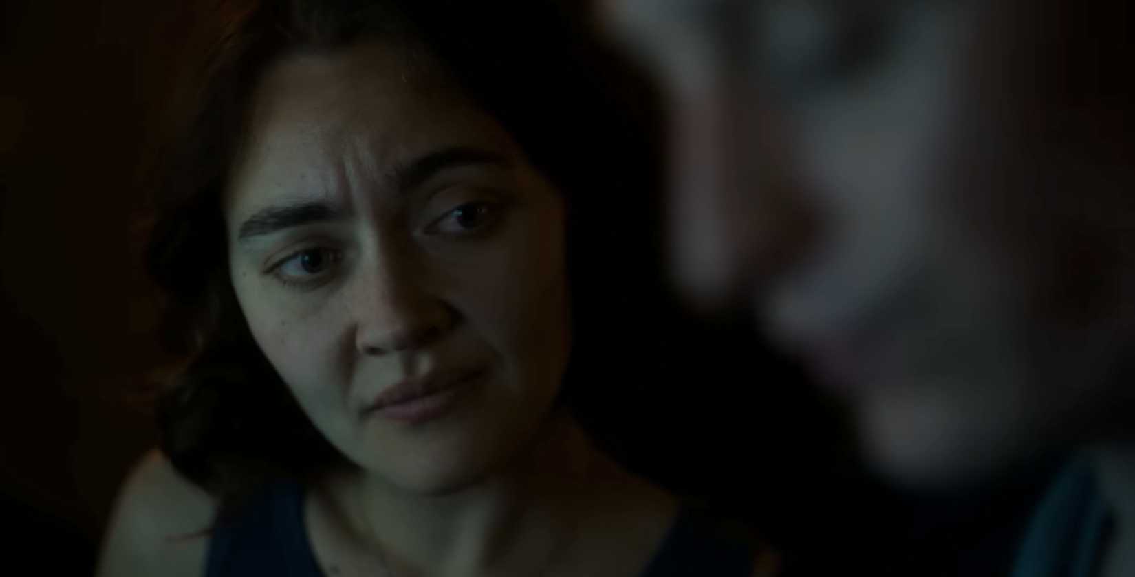 Actor Jamie Taylor Ballesta, a brunette woman with short brown hair, looks at her scene partner with concern