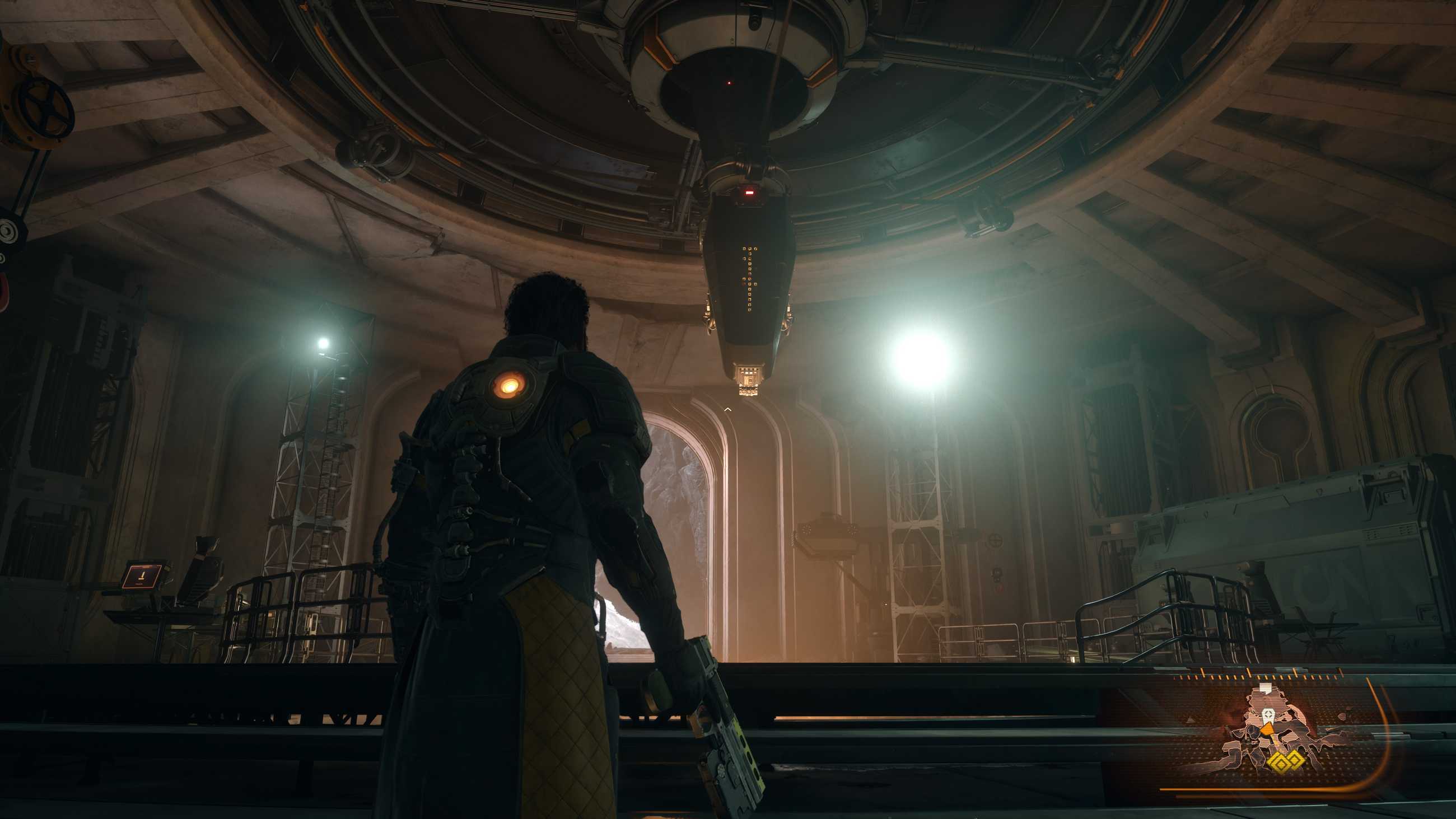 Devraj stares at an AI machine in Saros.