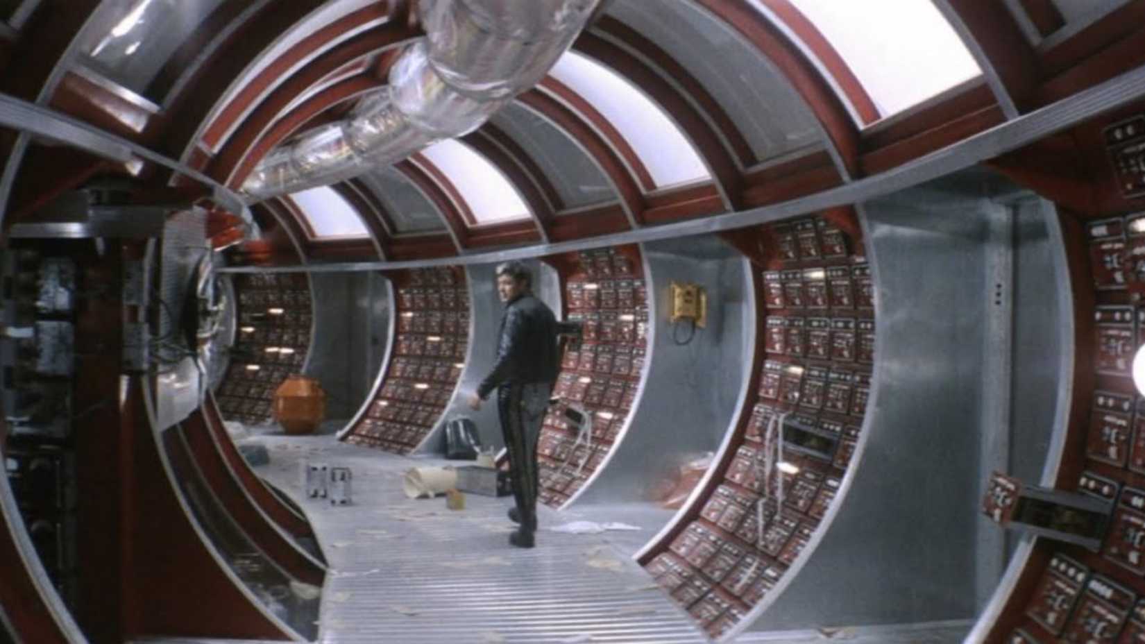Still from the movie Solaris featuring Kris Kelvin in a hallway on the space station.