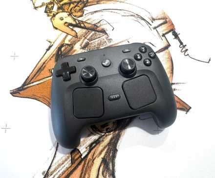 A Steam Controller sits on a white mousepad.