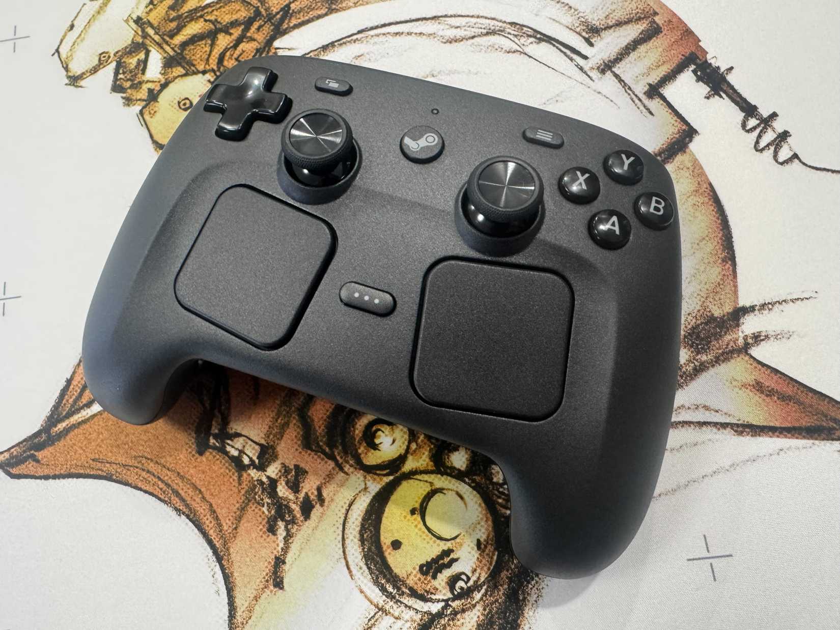 A Steam Controller sits on a white mousepad.