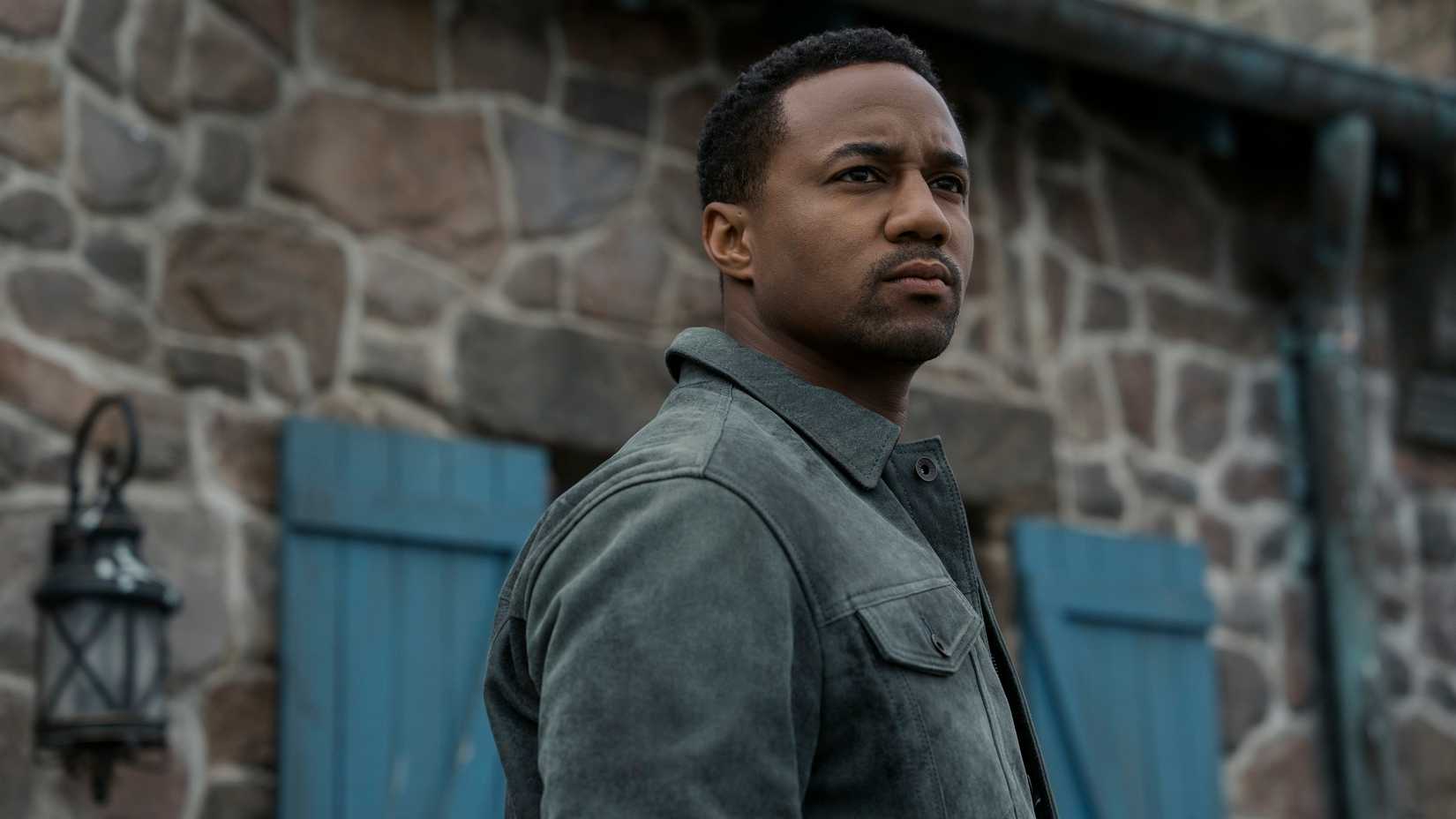 A-Train (Jessie T. Usher) stands outside a stone building in The Boys