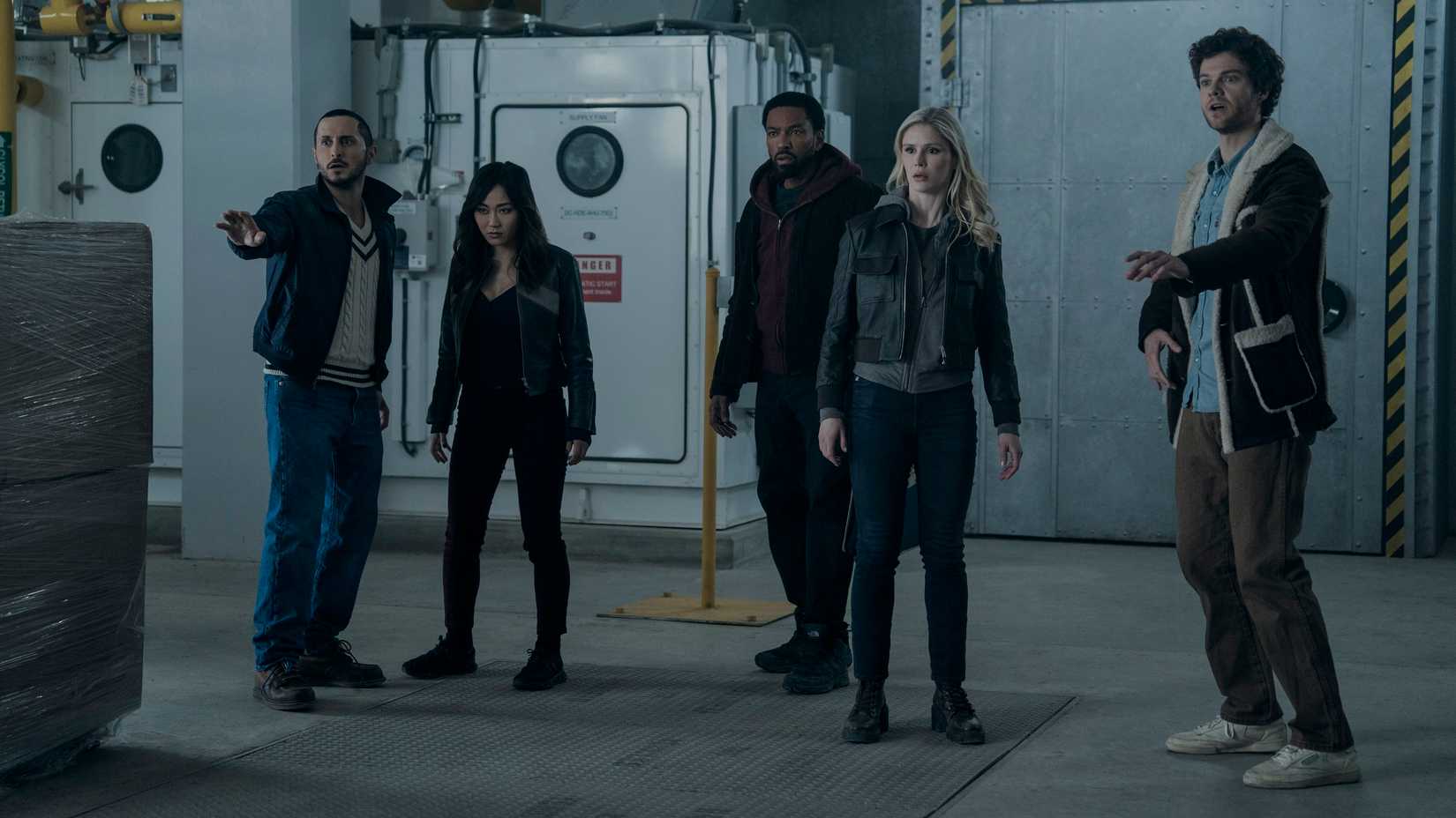 Tomer Capone (Frenchie), Karen Fukuhara (Kimiko), Karl Urban (Billy Butcher), Erin Moriarty (Annie January aka Starlight) and Jack Quaid (Hughie Campbell) stand in a warehouse lab looking worried in The Boys